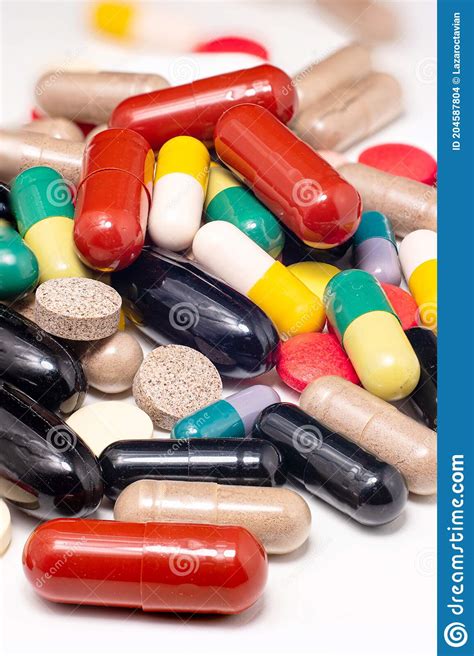 Variety Of Colorful Medical Pills Spread On White Surface Large Depth