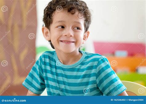 Portrait Of Cute Caucasian Boy Smiling In Classroom School Happy White