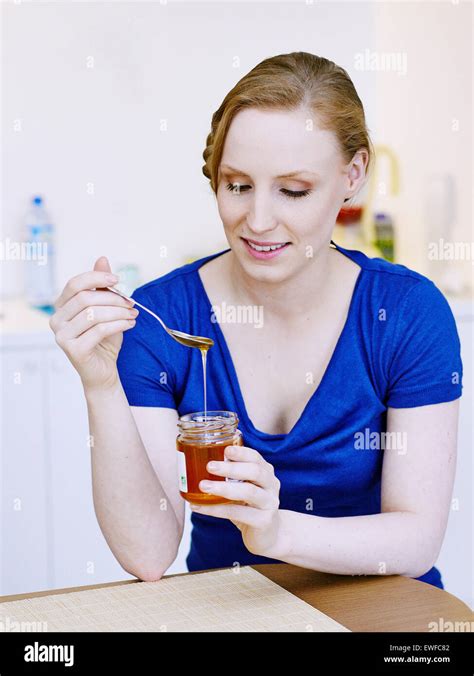 Woman Eating Honey Stock Photo Alamy