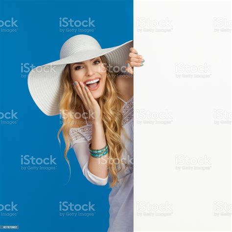 Laughing Beautiful Woman In White Sun Hat Is Peeking Behind Banner