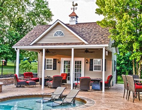 A Small Pool House With Chairs Around It And A Hot Tub On The Patio