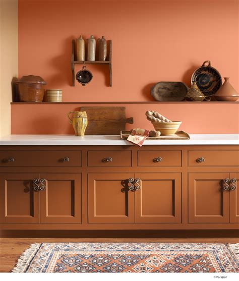 The warmth of the orange accents is tempered by the cool blue and brick tones. An orange wall can bring extra rustic warmth to any kitchen. Color Name: Valspar Toasted Apric ...