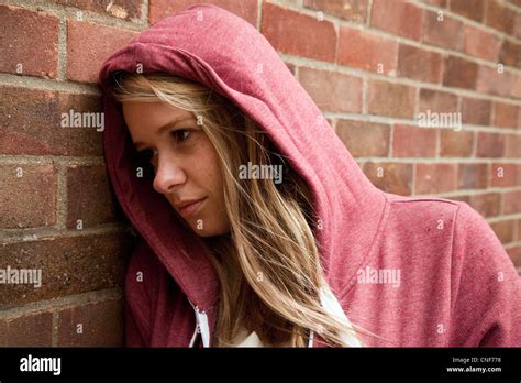 Blonde Teenage Girl Wearing A Hoodie Leaning Against A Wall Billericay