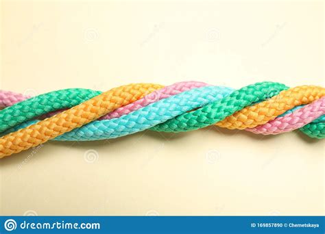 Twisted Colorful Ropes On Beige Background Top View Unity Concept
