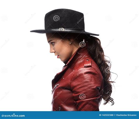 Brunette Woman Wears A Black Hat And A Leather Jacket Stock Photo