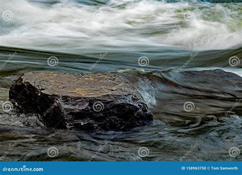 Rock Stands Solid In A Powerful Current Stock Photo Image Of Leveled