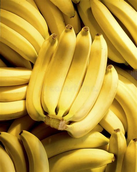 Several Bunches Of Bananas Stacked On Top Of Each Other