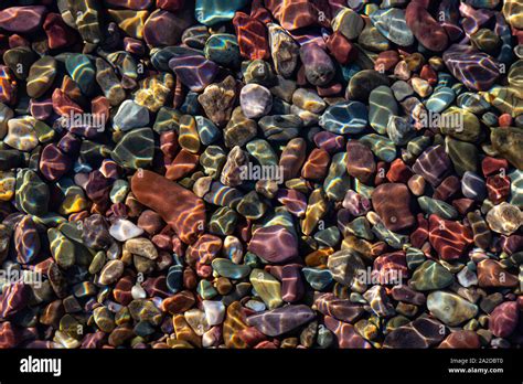 Colorful Rocks In A Glacier Lake During A Sunny Summer Day Taken In