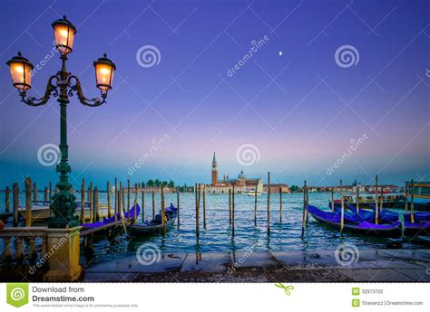 Venice Street Lamp And Gondolas Or Gondole On Sunset And Church On