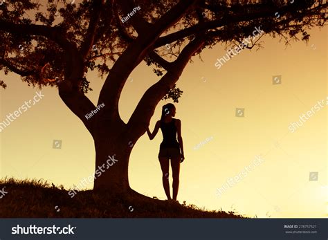 Young Woman Standing Next Tree Enjoying Stock Photo 278757521