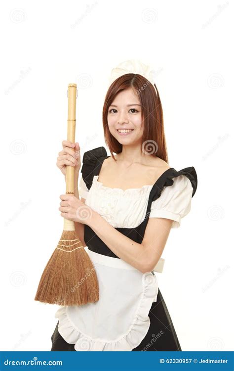 Young Japanese Woman Wearing French Maid Costume With Broom Stock Image