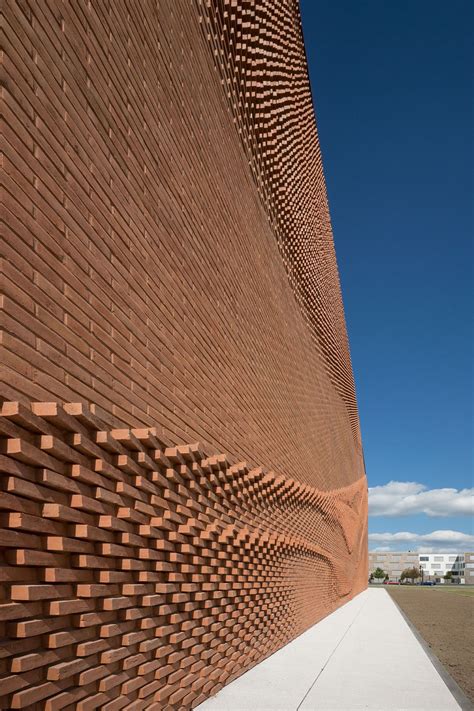 An Undulating Brick Facade Imitates The Free Flowing Movement Of Draped