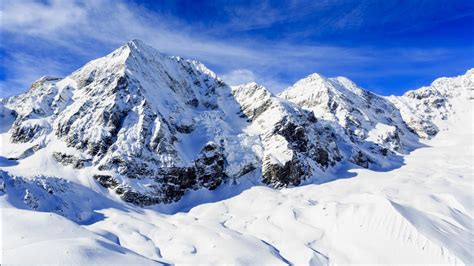 Snow Covered Mountain With Background Of Blue Sky With Clouds During