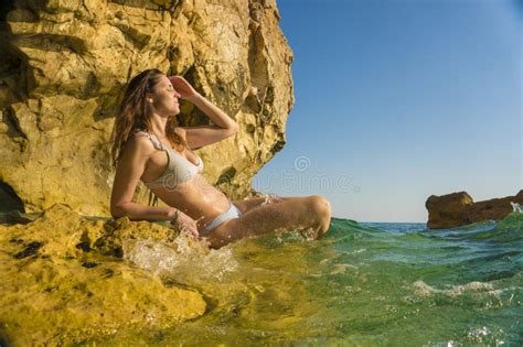 Woman Or Girl With Bikini Sitting On The Rock By The Sea Beach Stock
