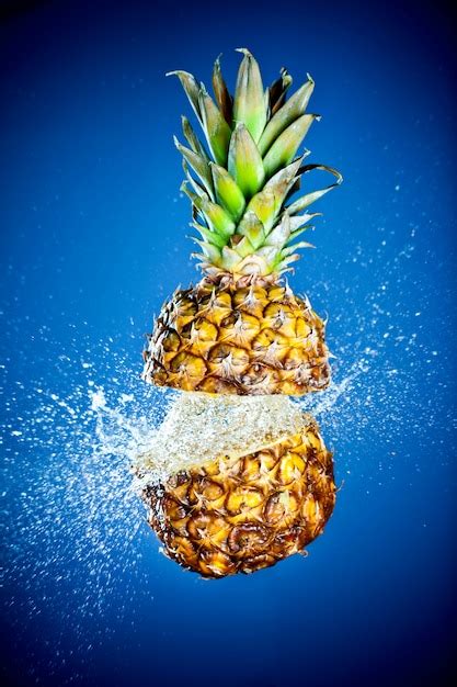 Premium Photo Pineapple Splashed With Water On A Blue Wall