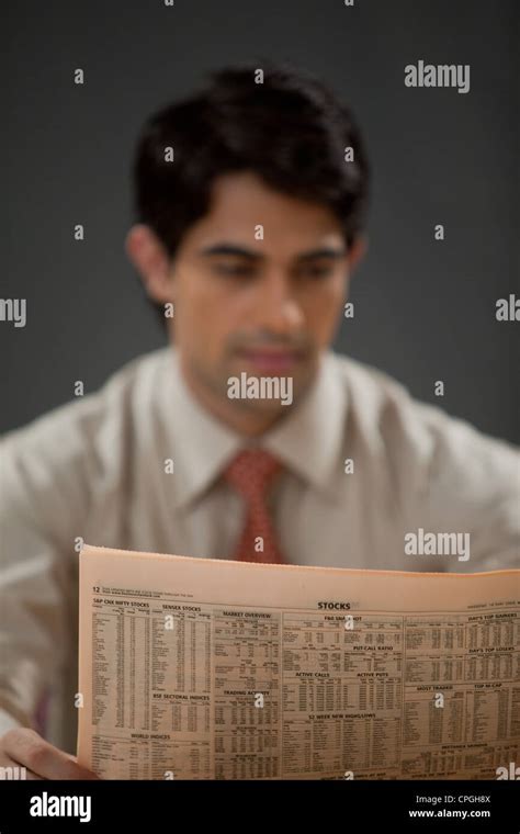 Young Businessman Reading Newspaper Stock Photo Alamy