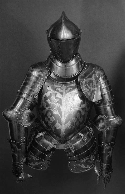 The Armor Is Made Up Of Metal And Has Ornate Designs On Its Sides