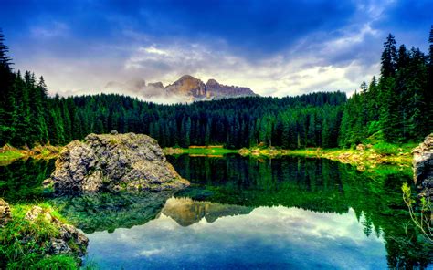Blue Sky With White Clouds The Green Pine Trees Rocks Peaceful Lake