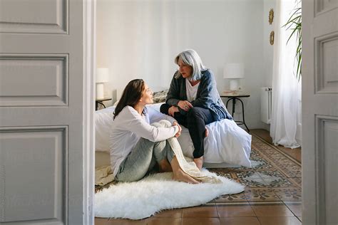 Mother And Her Daughter Talking Together On The Room At Morning By