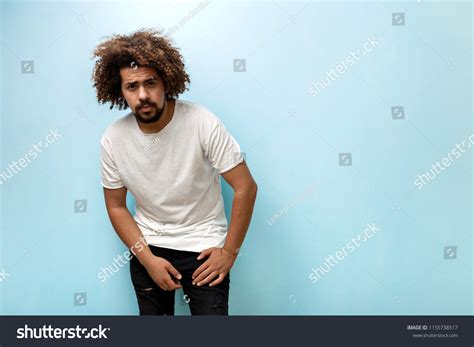 Curlyheaded Brunet Man Leaning Forwards Wearing Stock Photo 1155738517