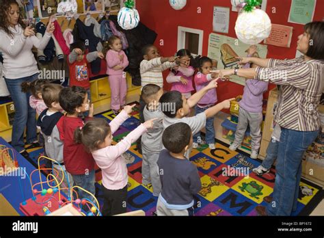 Preschool Teacher And Students Singing Stock Photo Alamy