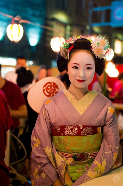 beautiful maiko san serving beer during the gion matsuri in kyoto