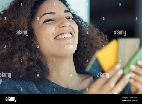 Curly Haired Young Woman Chooses Colors From A Wood Sample Palette For