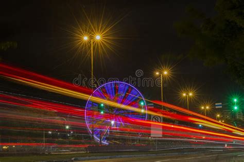 Long Exposure Of Colorful Ferris Wheel And Light Trails On The