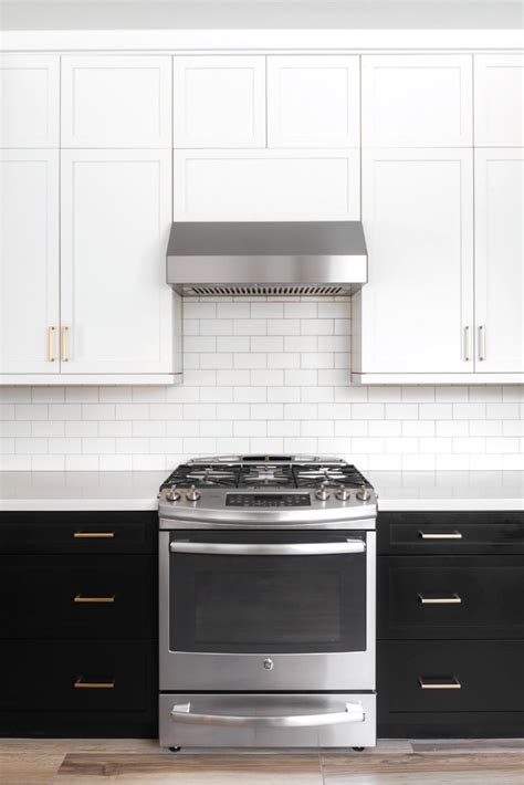 Antique white shaker ready to assemble (rta) kitchen cabinets bring a heightened style to your kitchen. White shaker upper cabinets paired with black shaker base cabinets. Gold hardware and white ...