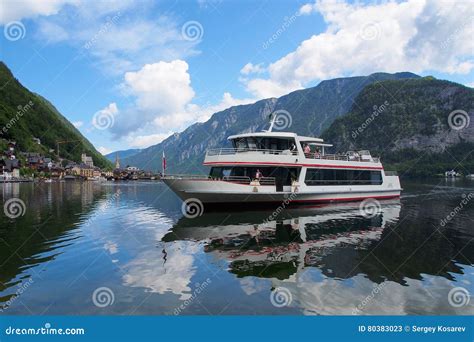 The Ferry Goes Across Lake Hallstatt Mountains As Background Austria