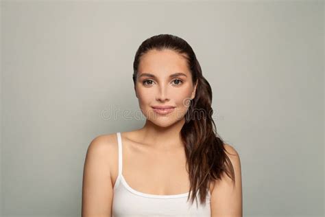 Cute Brunette Woman In A White Shirt Facial Treatment Skin Care