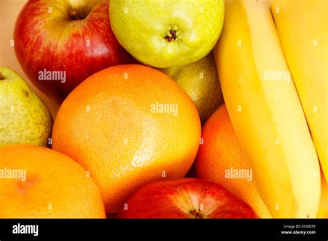 A Background Of Fruits Oranges Bananas Apples And Pears Stock Photo