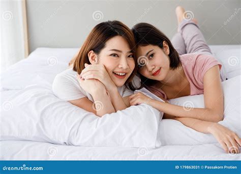Two Asian Women Lie Down On Bed Together Stock Image Image Of Indoors Beautiful 179863031