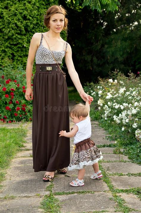 Young Mother Walks With The Child Stock Photo Image Of Bloom