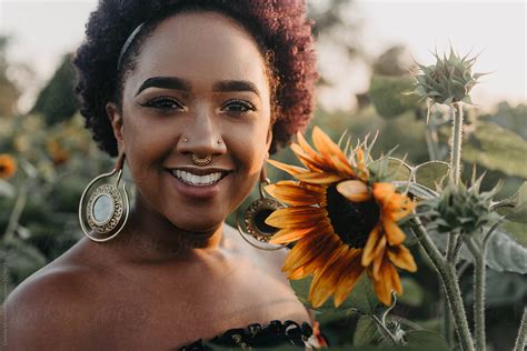 A Beautiful Young Black Woman Standing In A Field Of Flowers By Chelsea
