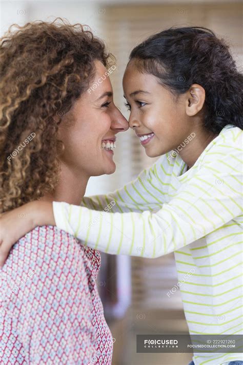 Happy Mother And Daughter Rubbing Noses Selective Focus Mid Adult Woman Stock Photo