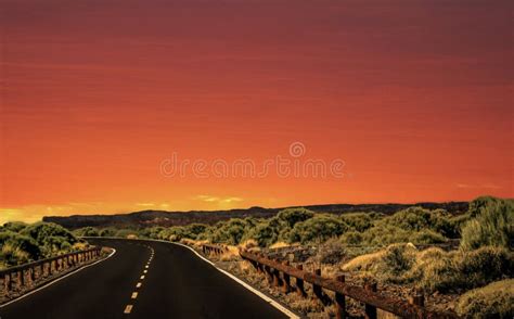 Natural Landscape Of Sky And Mountain Road With Vegetation At Sunset