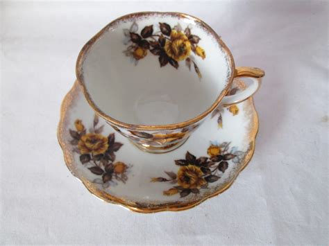 This splendid infusion will give you a flowery scent and a lingering taste. Vintage Tea cup and saucer Yellow flowers gray leaves gold ...