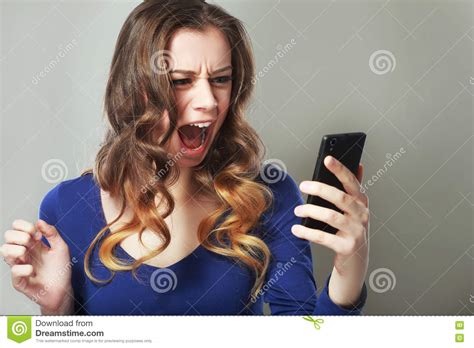 Shocked Woman Looking At Her Smart Phone Seeing Bad News Or Photos