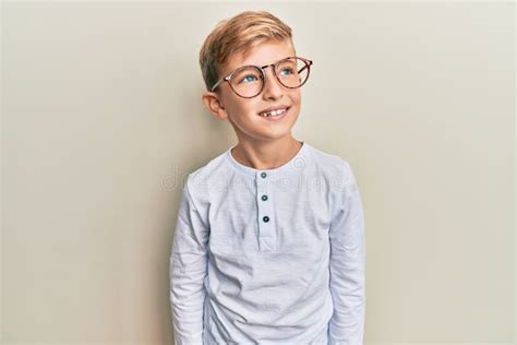 Little Caucasian Boy Kid Wearing Casual Clothes And Glasses Looking To