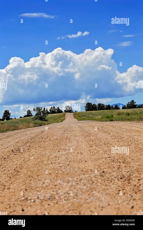 Vibrant Image Of A Long Dirt Road That Seems Never Ending With A Bright