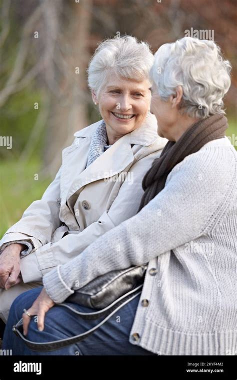 Catching Up With An Old Friend Two Smiling Senior Women Sitting