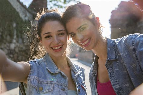 Two Happy Girlfriends Taking A Selfie Outdoors On Sunny Summer Day By Stocksy Contributor