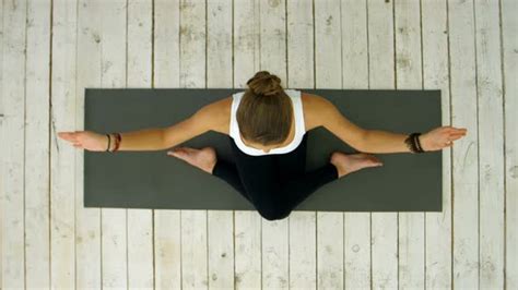 Sporty Beautiful Young Woman Practicing Yoga Sitting In Cross Legged