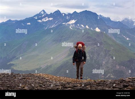 Climber With A Hiking Backpack In Mountains Tourist In Svaneti On A