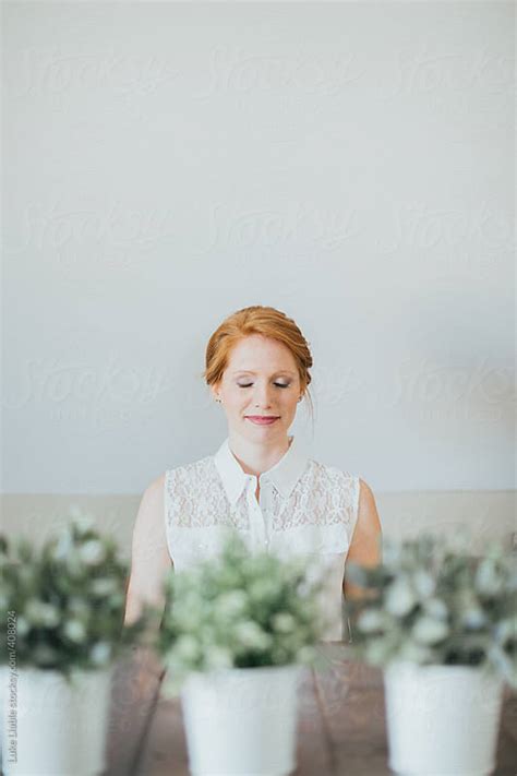Fashionable Redhead Sitting At Harvest Table By Luke Liable Stocksy