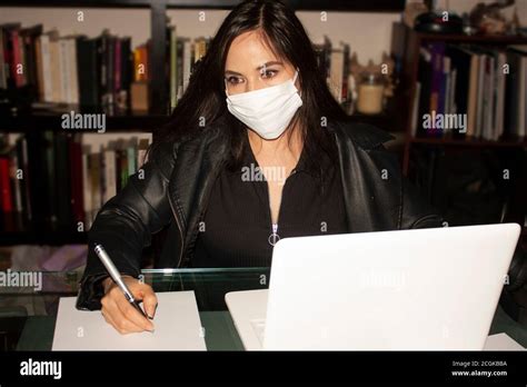 Amber Eyed Woman Wearing White Mouth Cover Correctly Covering Nose And Mouth Writes On White