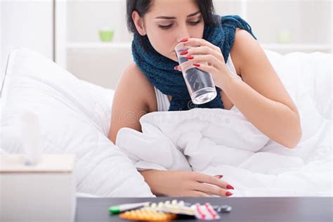 sick woman in bed with thermometer is having high temperature fever stock image image of cold