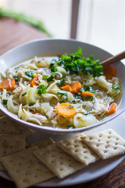 Chicken with noodles, celery and carrots in the most delicious broth. Slow Cooker Chicken Noodle Soup | Food with Feeling