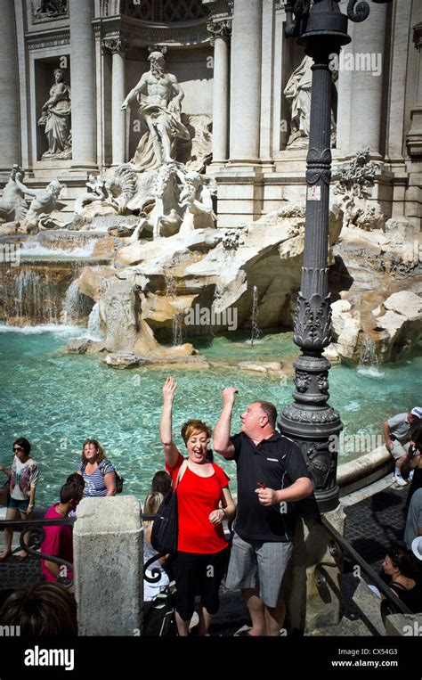 Couple Throwing Coins Into Trevi Fountain Rome Italy Stock Photo Alamy